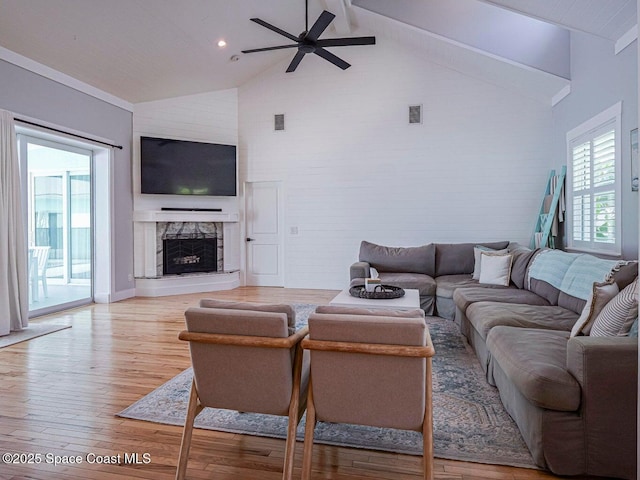 406 9th Ct, Vero Beach, FL 32962 - living room featuring a ceiling fan, beamed ceiling, light wood-style flooring, high vaulted ceiling, and a stone fireplace