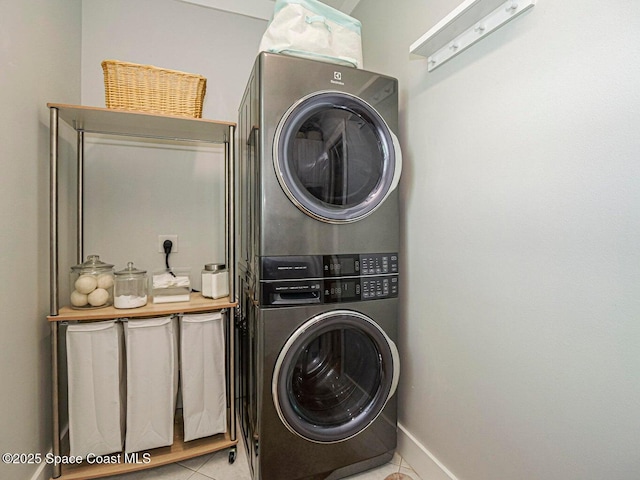 406 9th Ct, Vero Beach, FL 32962 - washroom with stacked washing machine and dryer and light tile patterned flooring