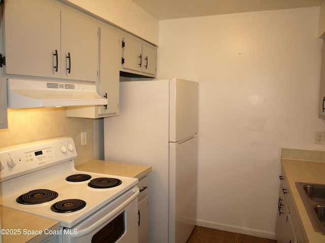 292 San Juan Cir, Melbourne, FL 32935 - kitchen featuring white appliances, under cabinet range hood, light countertops, wood finished floors, and white cabinets