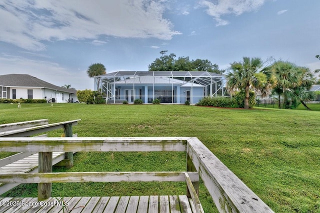 770 S Easy St, Sebastian, FL 32958 - rear view of property featuring a lawn and glass enclosure