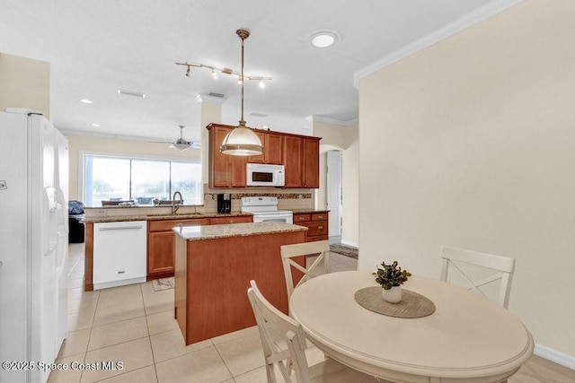 770 S Easy St, Sebastian, FL 32958 - kitchen with white appliances, a center island, ornamental molding, a ceiling fan, and backsplash