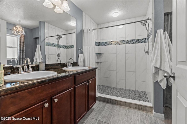 1787 Attilburgh Blvd, West Melbourne, FL 32904 - full bathroom with a textured ceiling, tiled shower, a chandelier, and double vanity