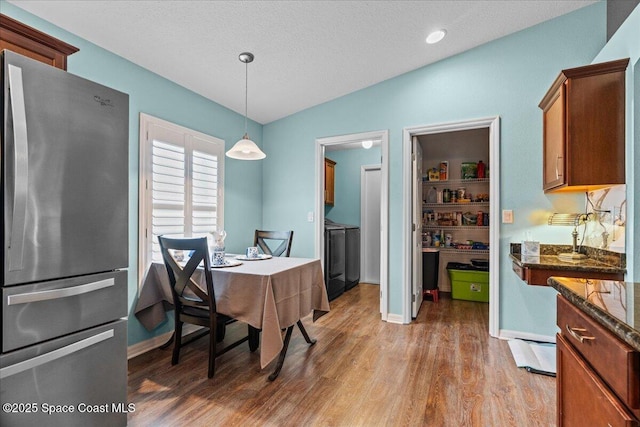 1787 Attilburgh Blvd, West Melbourne, FL 32904 - dining room featuring lofted ceiling, light wood-style floors, and washer / dryer