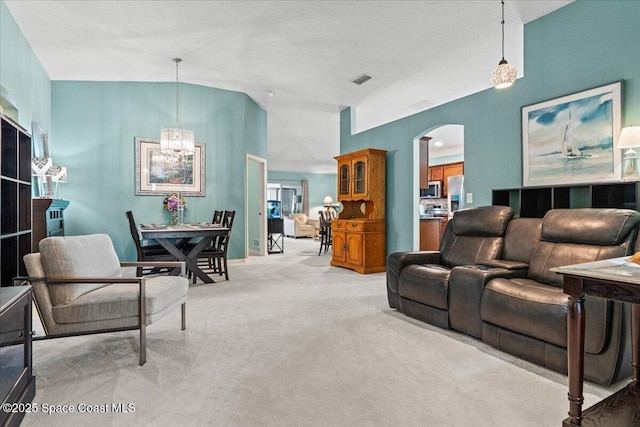 1787 Attilburgh Blvd, West Melbourne, FL 32904 - living area with vaulted ceiling, arched walkways, light carpet, and a chandelier