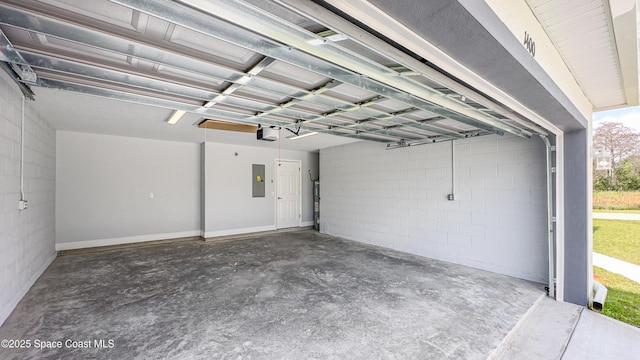 2181 Wagonwheel Ave SE, Palm Bay, FL 32909 - garage featuring electric panel, concrete block wall, and a garage door opener
