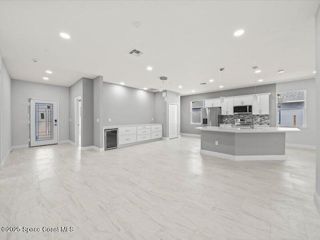 3358 Nancy St, West Melbourne, FL 32904 - unfurnished living room featuring recessed lighting and wine cooler