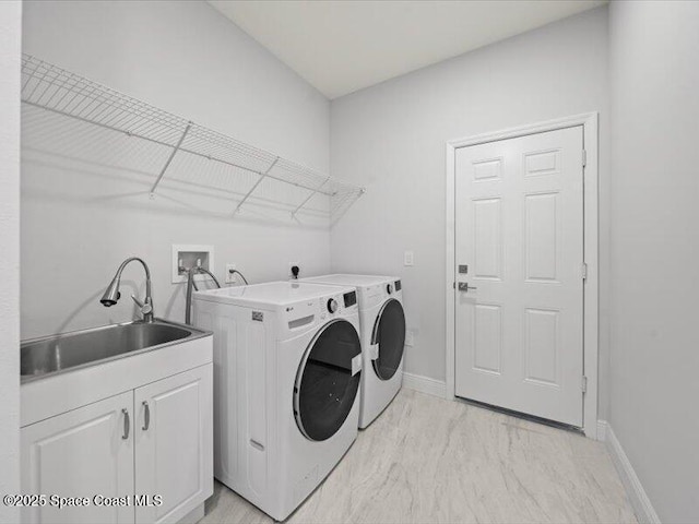 3358 Nancy St, West Melbourne, FL 32904 - laundry area with cabinet space, washing machine and dryer, and light marble finish flooring