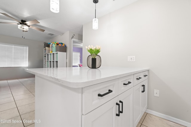845 Westport Dr, Rockledge, FL 32955 - kitchen featuring ceiling fan, white cabinetry, light stone counters, and pendant lighting