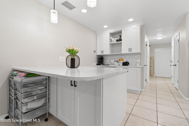 845 Westport Dr, Rockledge, FL 32955 - kitchen with open shelves, light tile patterned flooring, white cabinets, a peninsula, and recessed lighting