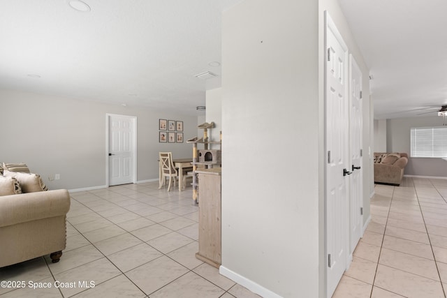 845 Westport Dr, Rockledge, FL 32955 - hallway with light tile patterned flooring and baseboards