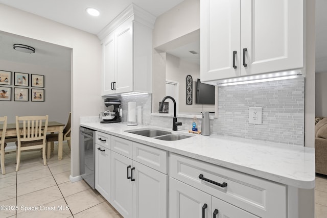 845 Westport Dr, Rockledge, FL 32955 - kitchen featuring white cabinets, decorative backsplash, light stone countertops, and light tile patterned floors