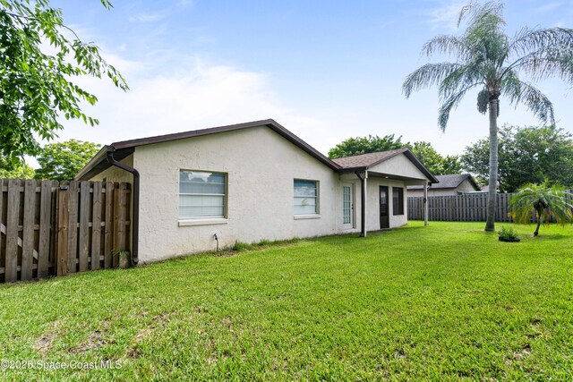 845 Westport Dr, Rockledge, FL 32955 - rear view of property featuring stucco siding and a fenced backyard