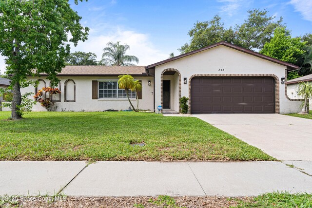 845 Westport Dr, Rockledge, FL 32955 - view of front of property with stucco siding, a garage, a front yard, and driveway
