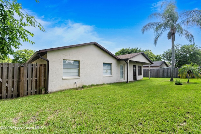 845 Westport Dr, Rockledge, FL 32955 - back of house with stucco siding and a fenced backyard