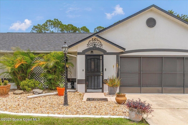 2595 Diane Ave SE, Palm Bay, FL 32909 - view of front of home featuring concrete driveway, an attached garage, and roof with shingles