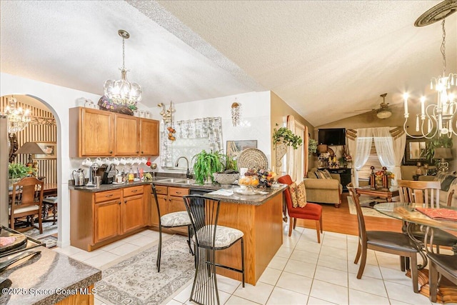 2595 Diane Ave SE, Palm Bay, FL 32909 - kitchen with a chandelier, lofted ceiling, dark countertops, a textured ceiling, and light tile patterned floors