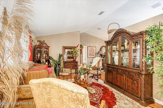 2595 Diane Ave SE, Palm Bay, FL 32909 - living area with lofted ceiling, wood finished floors, and a textured ceiling