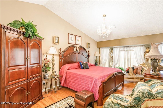 2595 Diane Ave SE, Palm Bay, FL 32909 - bedroom with vaulted ceiling, a chandelier, and light wood-style flooring