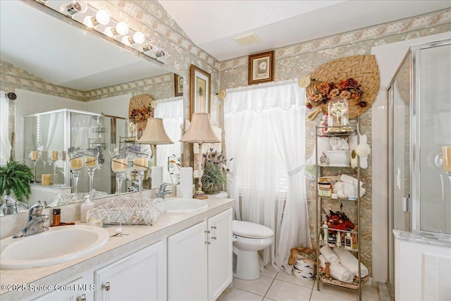 2595 Diane Ave SE, Palm Bay, FL 32909 - full bath featuring tile patterned floors, a stall shower, double vanity, and wallpapered walls
