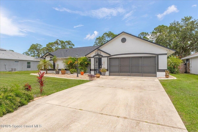 2595 Diane Ave SE, Palm Bay, FL 32909 - view of front of house with driveway, a front yard, a garage, and stucco siding