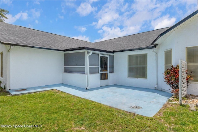 2595 Diane Ave SE, Palm Bay, FL 32909 - rear view of house featuring a shingled roof, a yard, a patio area, and stucco siding