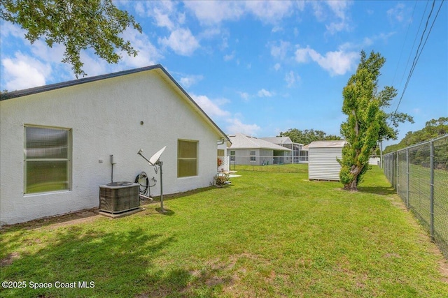 2595 Diane Ave SE, Palm Bay, FL 32909 - fenced backyard featuring a storage unit