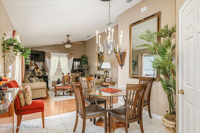 2595 Diane Ave SE, Palm Bay, FL 32909 - dining room with healthy amount of natural light, a ceiling fan, light tile patterned floors, and vaulted ceiling
