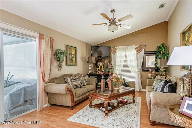 2595 Diane Ave SE, Palm Bay, FL 32909 - living area with lofted ceiling, ceiling fan, and light wood-type flooring
