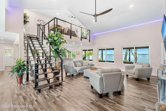 1379 Rose Ct, Melbourne, FL 32935 - living area with high vaulted ceiling, stairs, wood finished floors, and recessed lighting