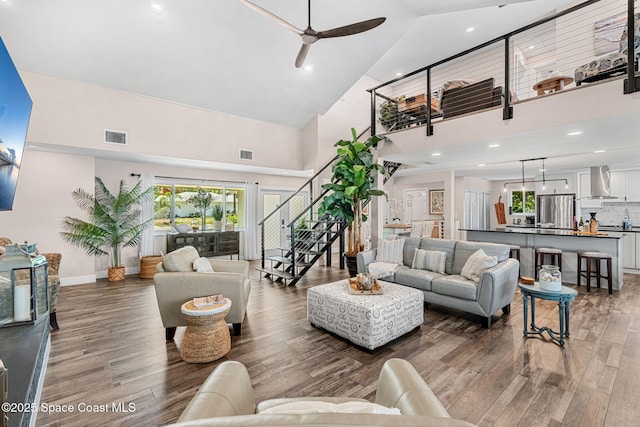 1379 Rose Ct, Melbourne, FL 32935 - living area with a high ceiling, stairs, ceiling fan, wood finished floors, and plenty of natural light