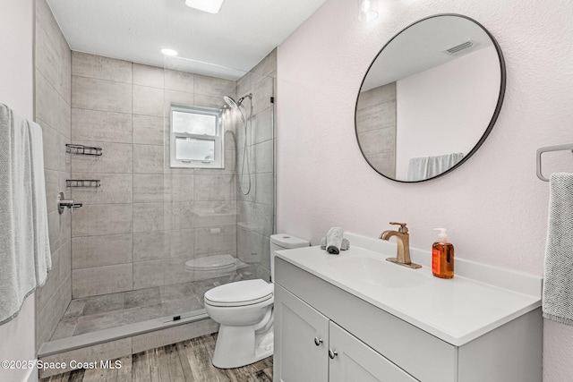 1379 Rose Ct, Melbourne, FL 32935 - bathroom featuring vanity, wood finished floors, and tiled shower
