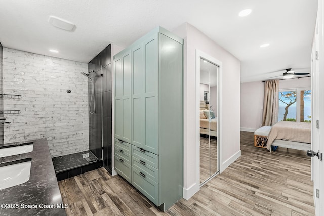 1379 Rose Ct, Melbourne, FL 32935 - bathroom featuring ensuite bath, tiled shower, wood finished floors, double vanity, and recessed lighting