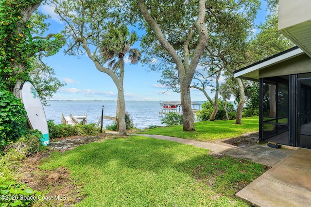 1379 Rose Ct, Melbourne, FL 32935 - view of green lawn with a water view and a sunroom