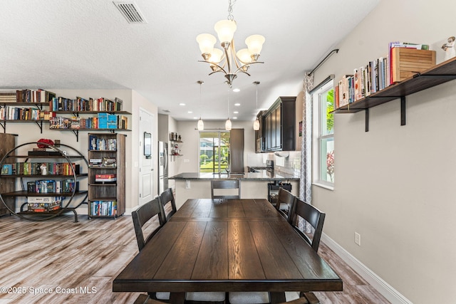 2920 Casterton Dr, Melbourne, FL 32940 - dining space with a chandelier, wood finished floors, and recessed lighting