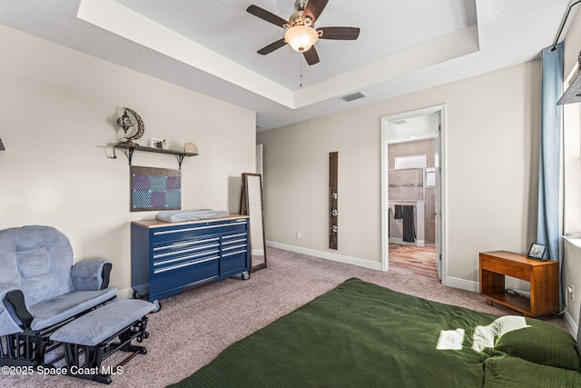 2920 Casterton Dr, Melbourne, FL 32940 - carpeted bedroom with a tray ceiling and a ceiling fan