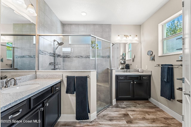 2920 Casterton Dr, Melbourne, FL 32940 - full bath with two vanities, wood finished floors, and a stall shower