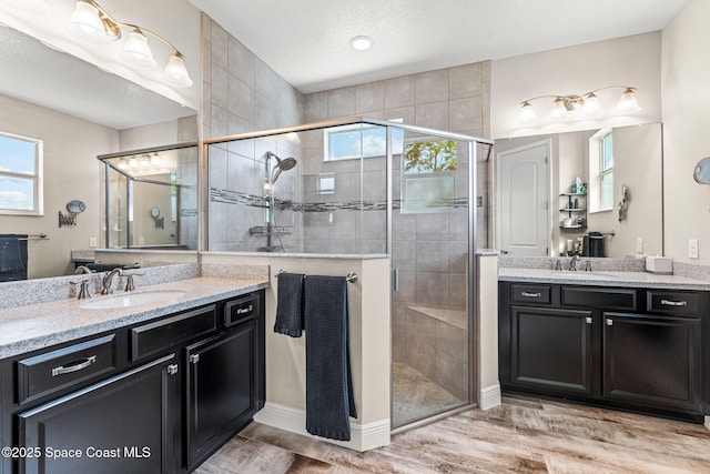 2920 Casterton Dr, Melbourne, FL 32940 - full bath featuring two vanities, a stall shower, and wood finished floors