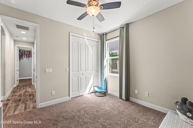 2920 Casterton Dr, Melbourne, FL 32940 - unfurnished bedroom with carpet, a closet, ceiling fan, and a textured ceiling