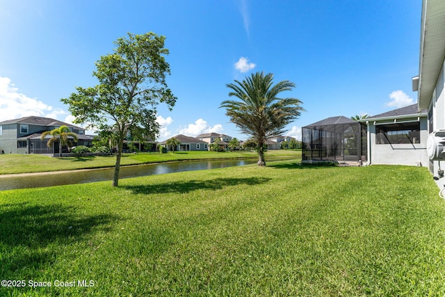 2920 Casterton Dr, Melbourne, FL 32940 - view of green lawn featuring a water view, a residential view, and a lanai