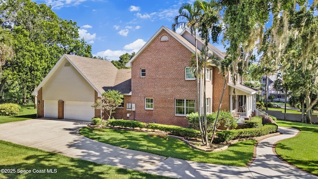 1407 Rockledge Dr, Rockledge, FL 32955 - view of home's exterior featuring brick siding, driveway, an attached garage, and a lawn
