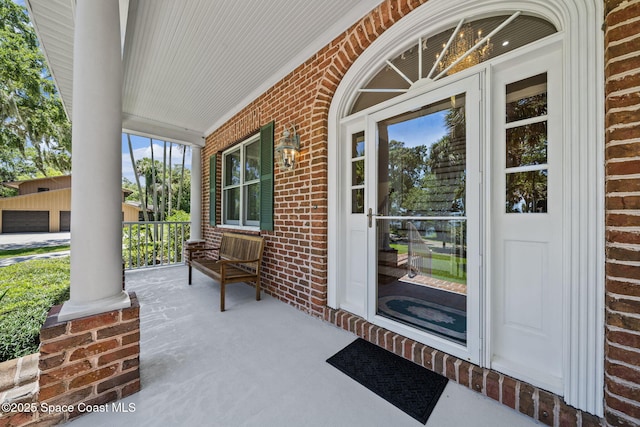 1407 Rockledge Dr, Rockledge, FL 32955 - view of exterior entry with a porch and brick siding