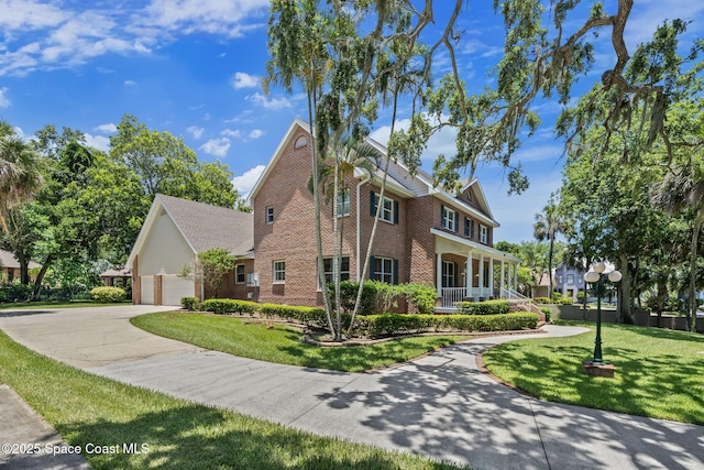 1407 Rockledge Dr, Rockledge, FL 32955 - view of front of property with brick siding, a garage, a front lawn, concrete driveway, and covered porch