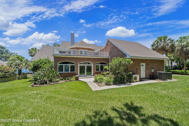 1407 Rockledge Dr, Rockledge, FL 32955 - rear view of house featuring a balcony, a yard, and brick siding
