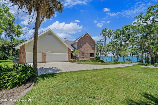 1407 Rockledge Dr, Rockledge, FL 32955 - view of front of house featuring brick siding, a front yard, a garage, and concrete driveway