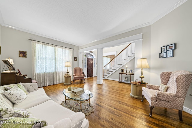 1407 Rockledge Dr, Rockledge, FL 32955 - living area featuring stairs, wood finished floors, and crown molding