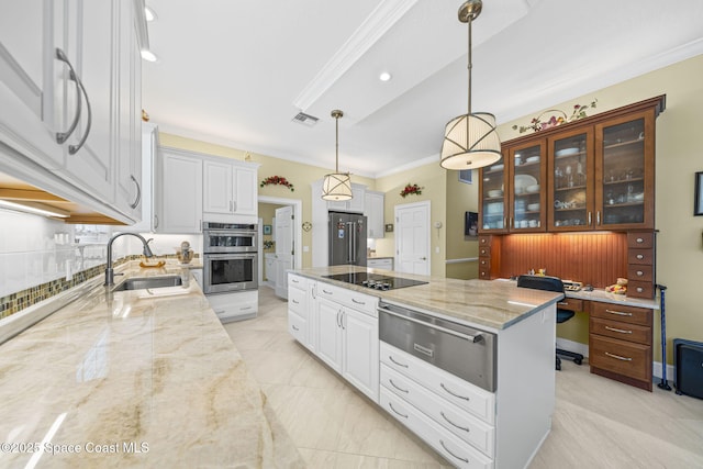 1407 Rockledge Dr, Rockledge, FL 32955 - kitchen with a warming drawer, appliances with stainless steel finishes, ornamental molding, light stone counters, and white cabinetry