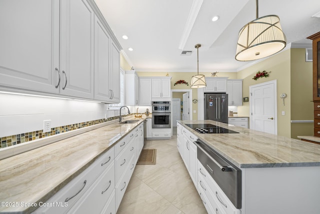 1407 Rockledge Dr, Rockledge, FL 32955 - kitchen with appliances with stainless steel finishes, a spacious island, light stone countertops, white cabinets, and recessed lighting