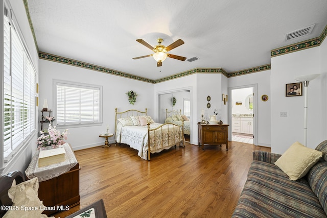 1407 Rockledge Dr, Rockledge, FL 32955 - bedroom featuring wood finished floors, a ceiling fan, and connected bathroom
