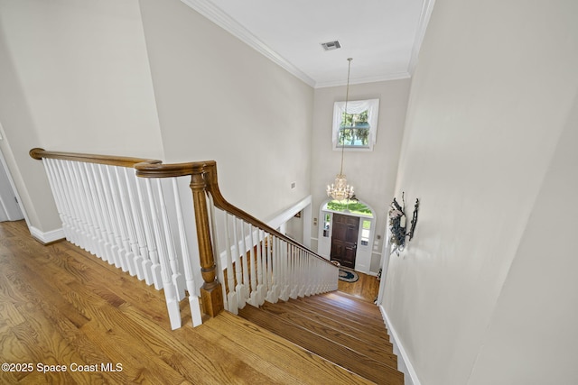 1407 Rockledge Dr, Rockledge, FL 32955 - stairs featuring a chandelier, wood finished floors, and ornamental molding