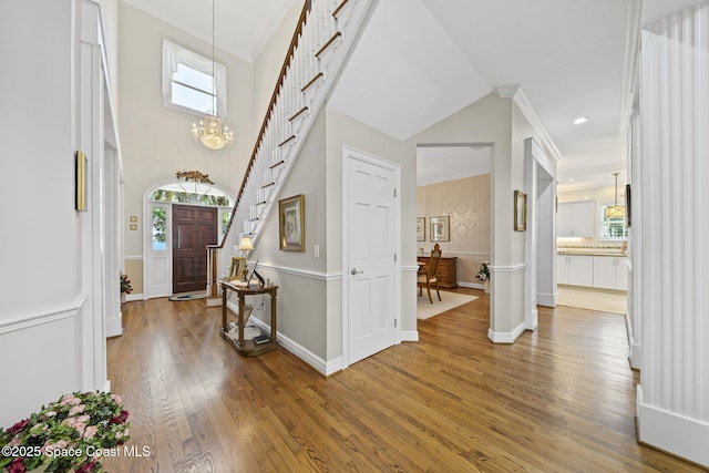 1407 Rockledge Dr, Rockledge, FL 32955 - entryway with wood finished floors, ornamental molding, stairway, and a chandelier